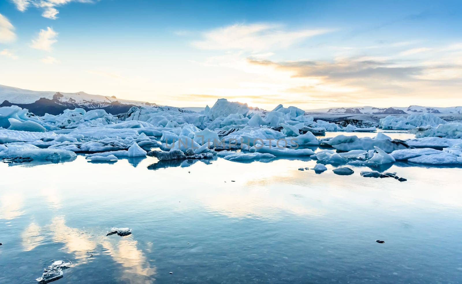 Beautiful view of icebergs in Jokulsarlon glacier lagoon at sunset, Iceland   selective focus