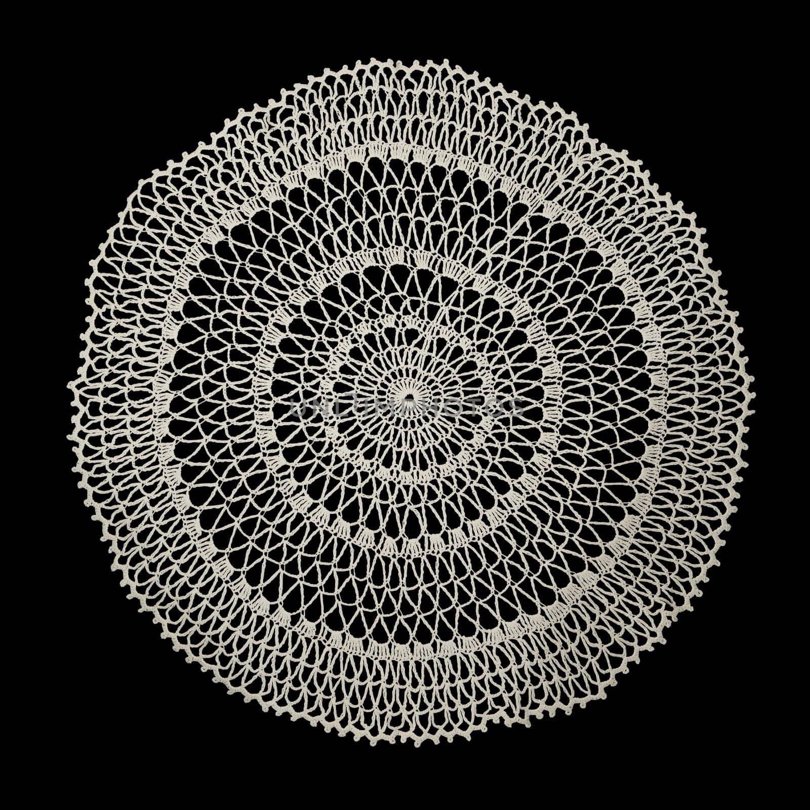 White handmade lace (round form), isolated on black.