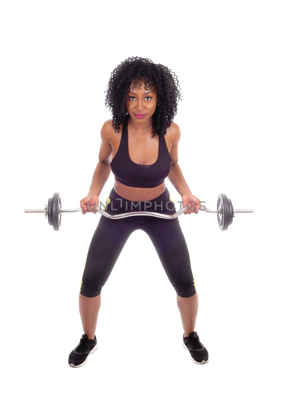 A young pretty African American woman in exercising outfit lifting weight,.with black curly hair, isolated for white background..
