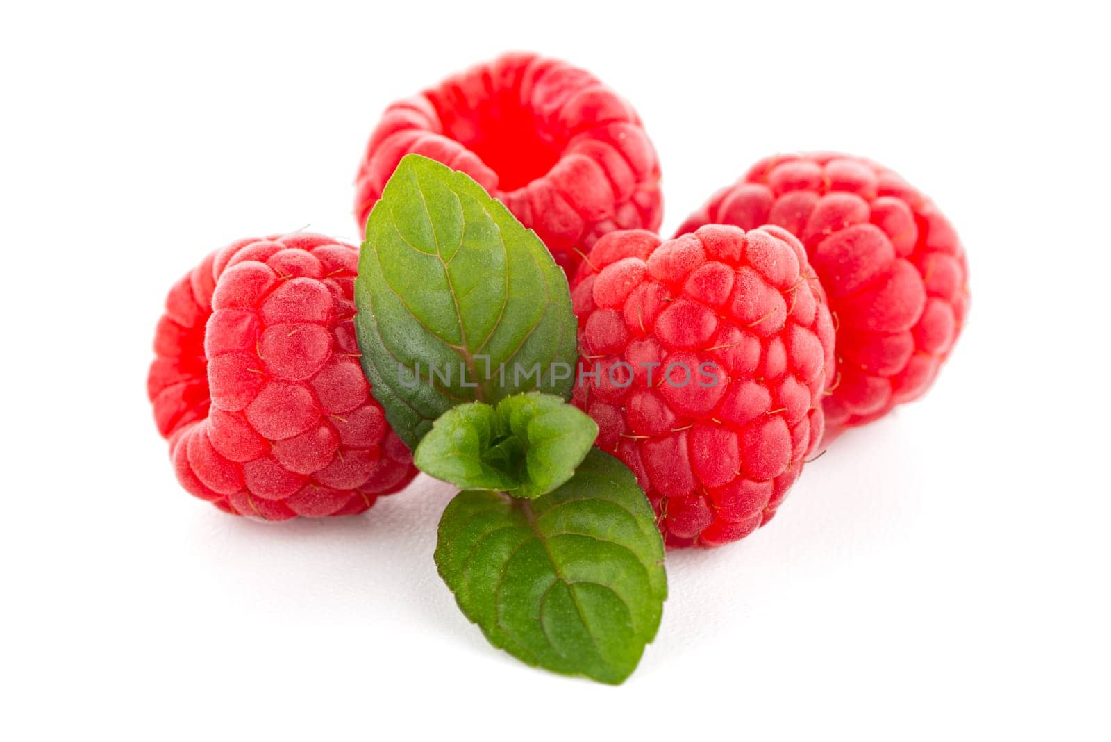 Raspberries with leaves isolated on white background