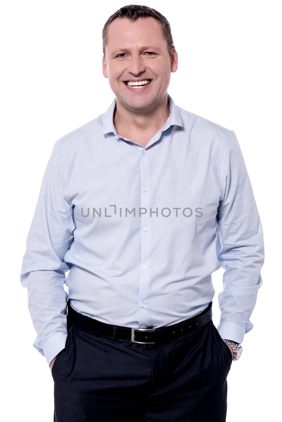 Confident handsome male smiling with hands in pockets