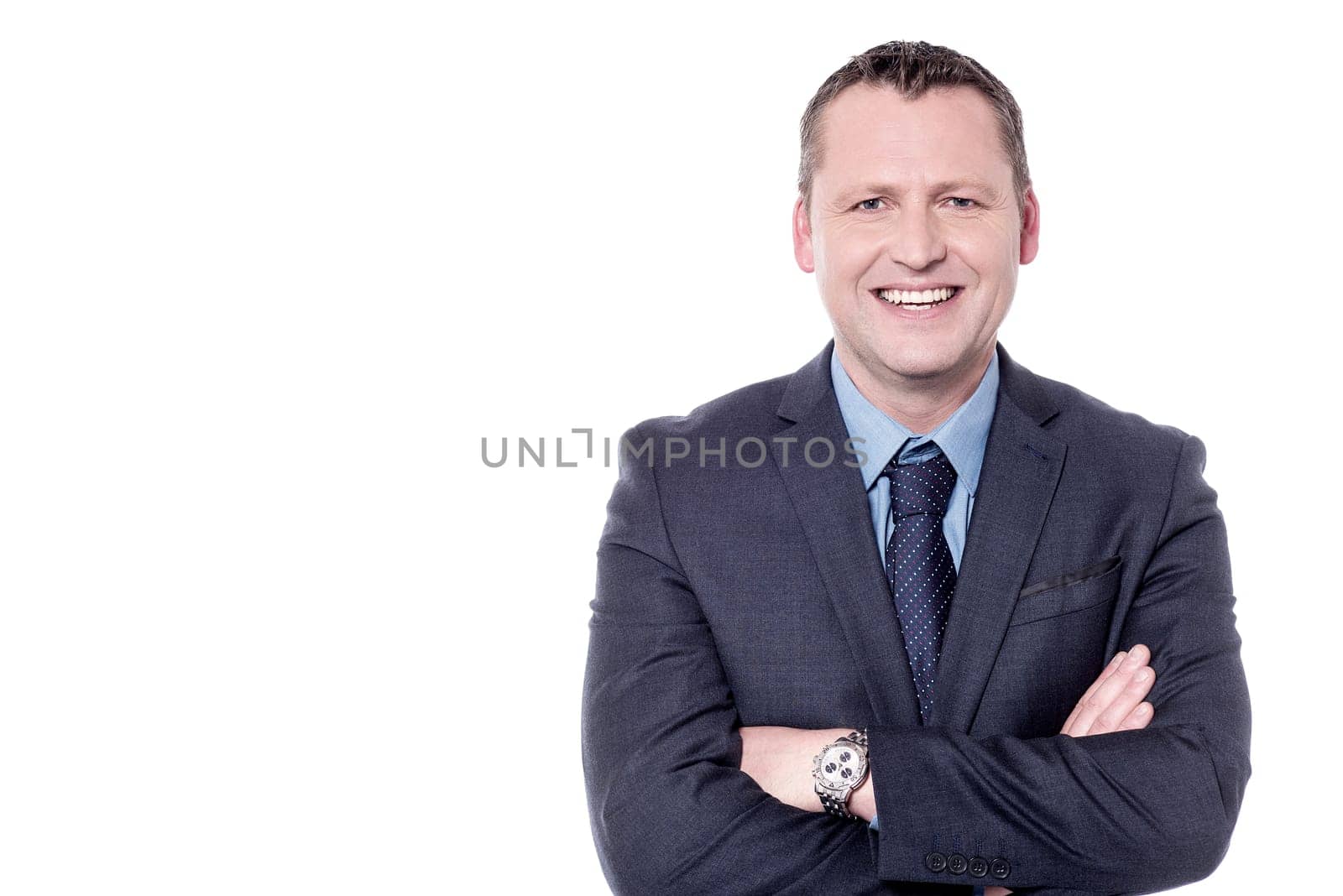 Smiling male entrepreneur posing with folded arms