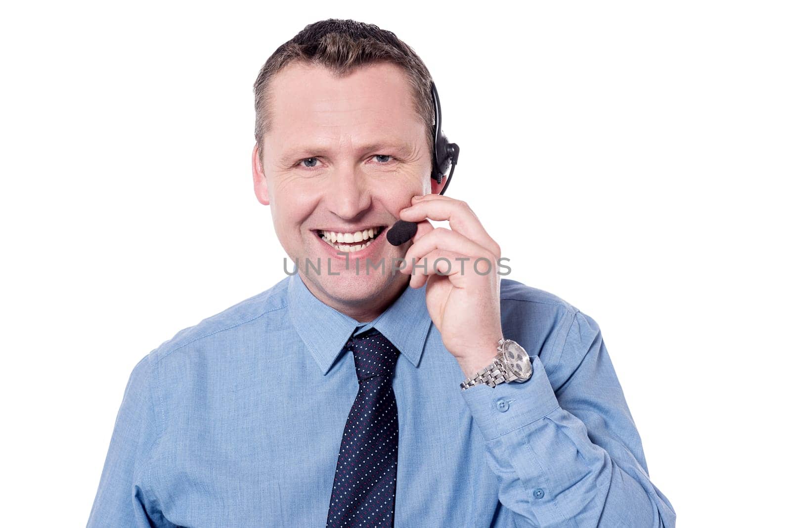 Smiling customer support executive talking over headphone