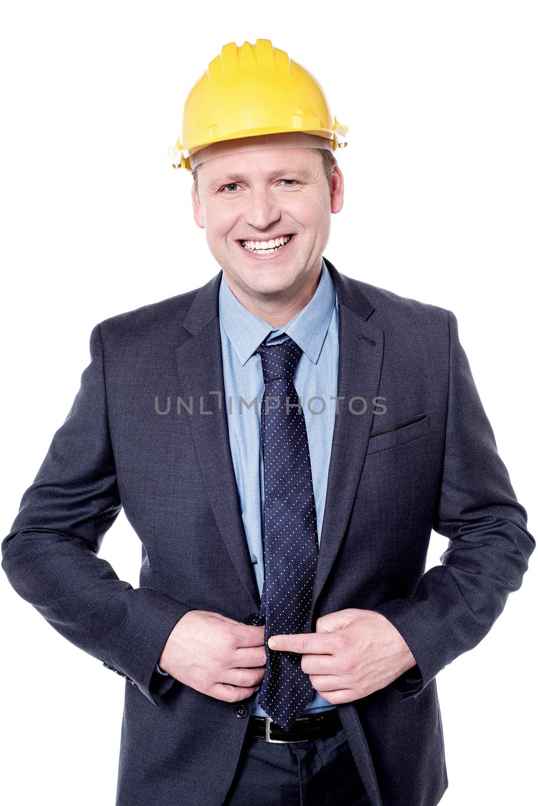 Smiling male engineer posing with yellow hardhat
