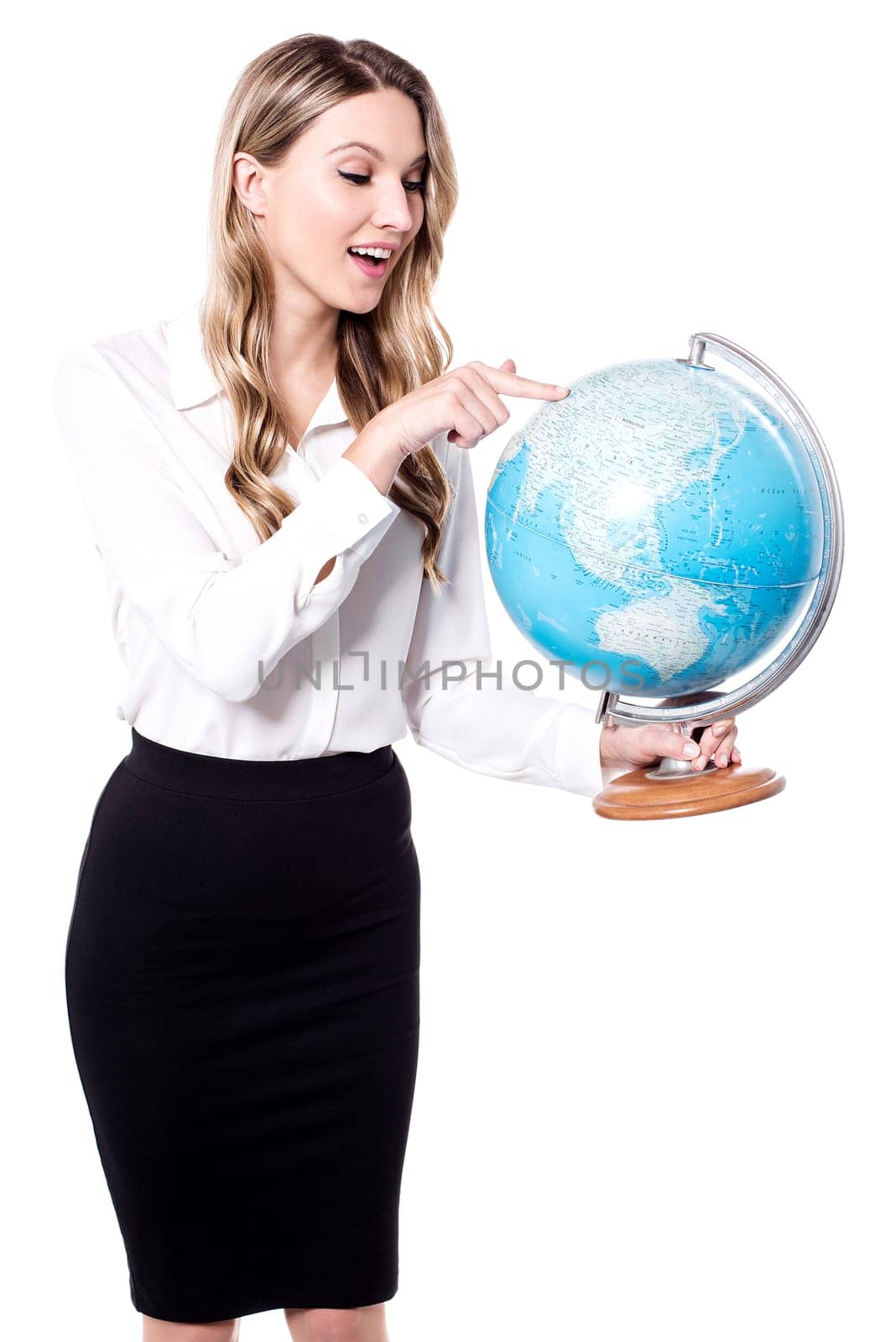 Pretty business woman pointing on earth globe