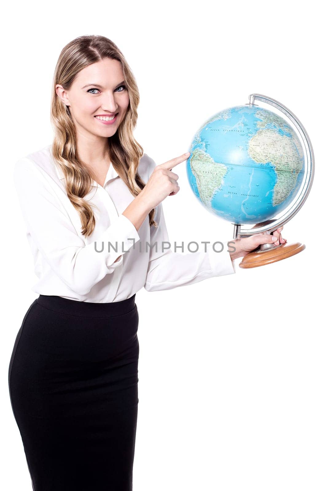 Beautiful young woman holding globe and pointing on it