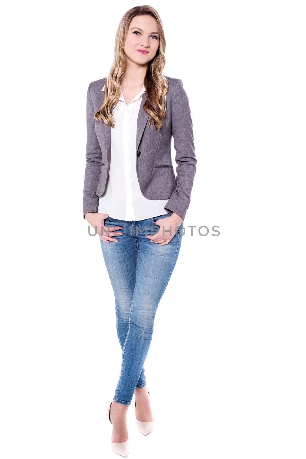 Casual young woman posing to camera with hands in pockets