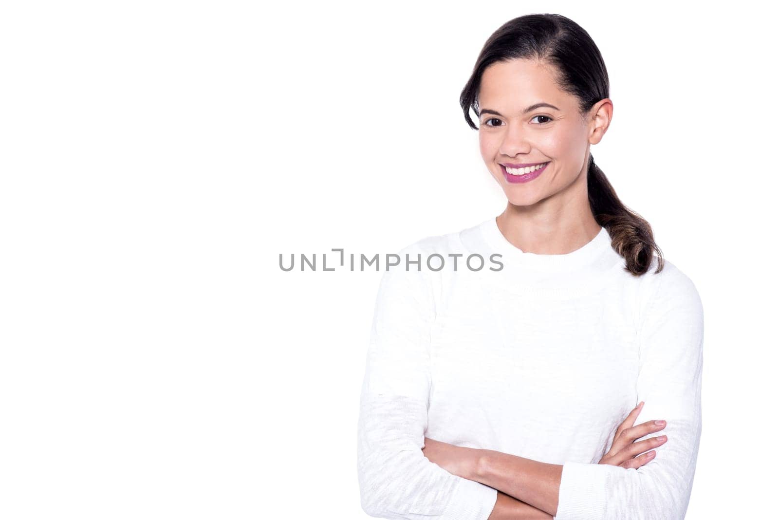 Young girl with a radiant smile, arms crossed