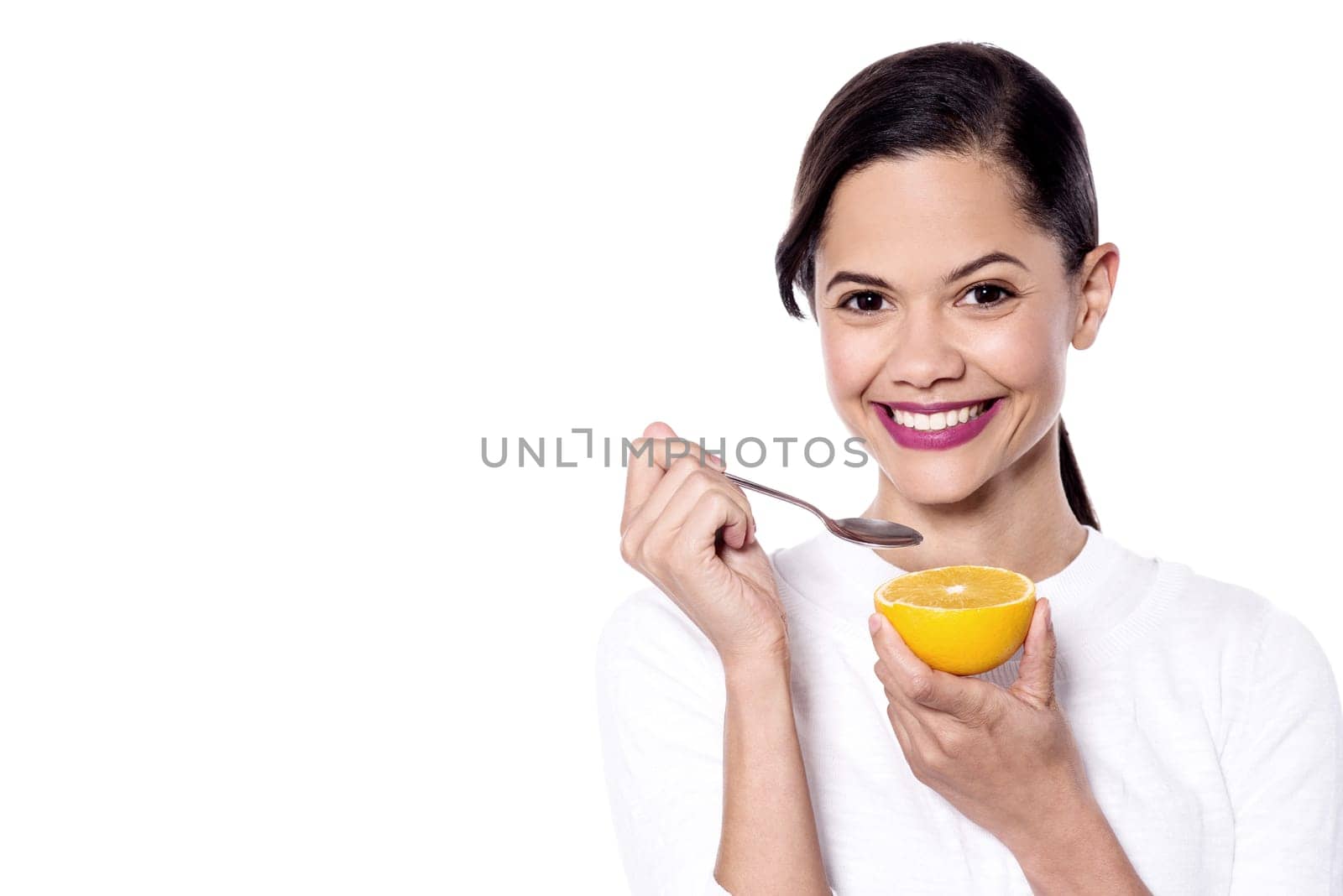 Beautiful woman holding half of orange over white