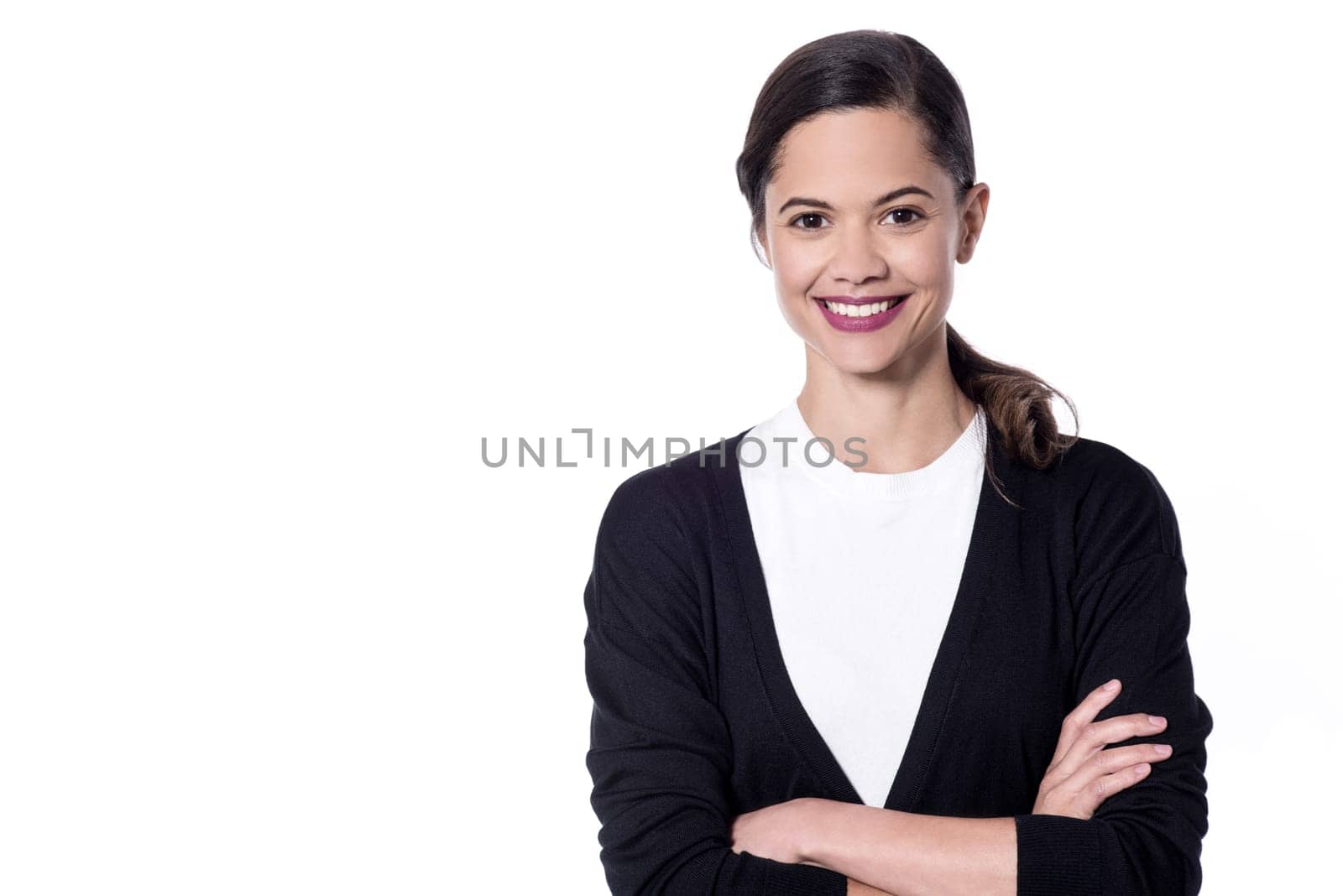 Happy young woman posing with folded arms