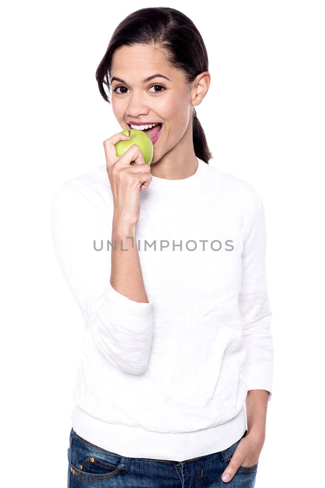 Picture of a young woman eating green apple