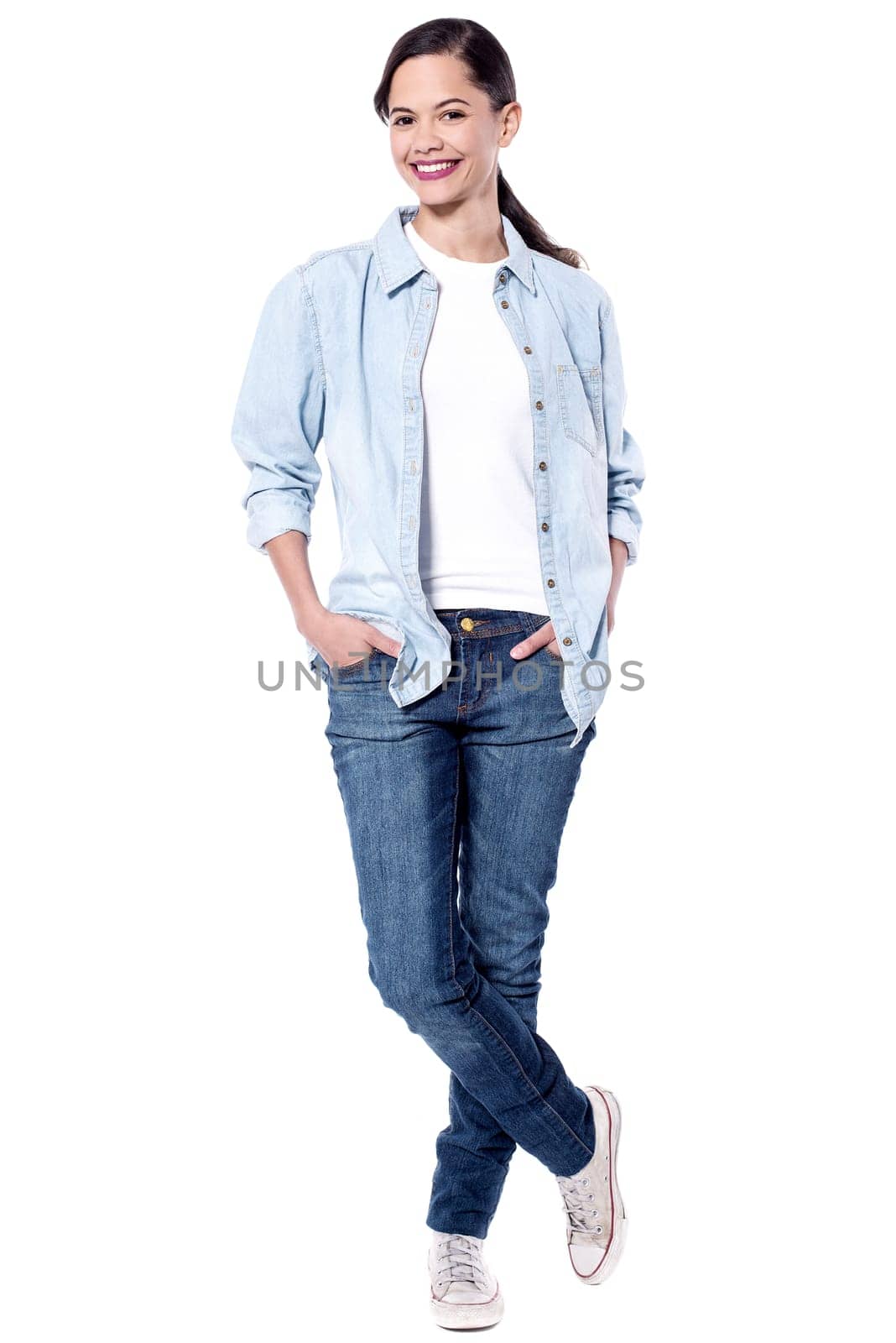 Casual young woman posing to camera with hands in pockets
