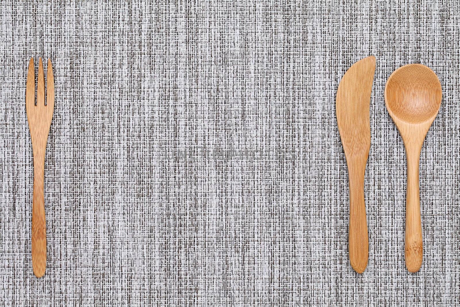 natural wooden spoon and fork, knife on tablecloth