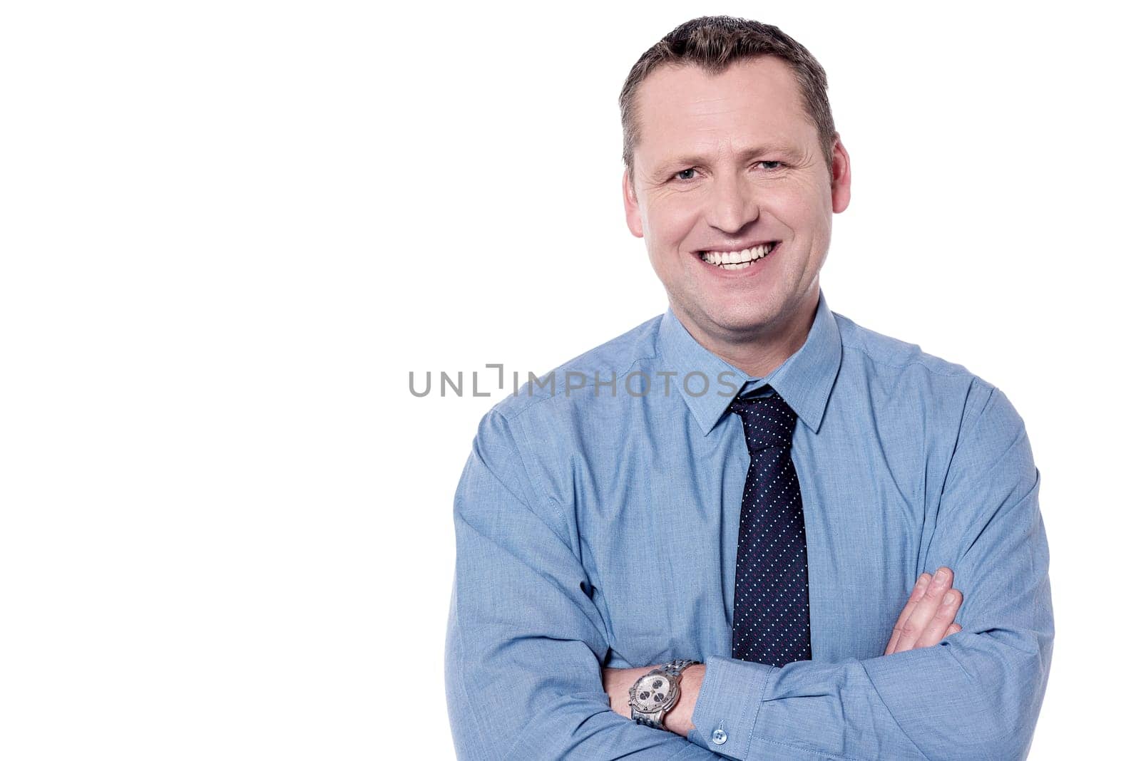 Smiling male executive posing with folded arms