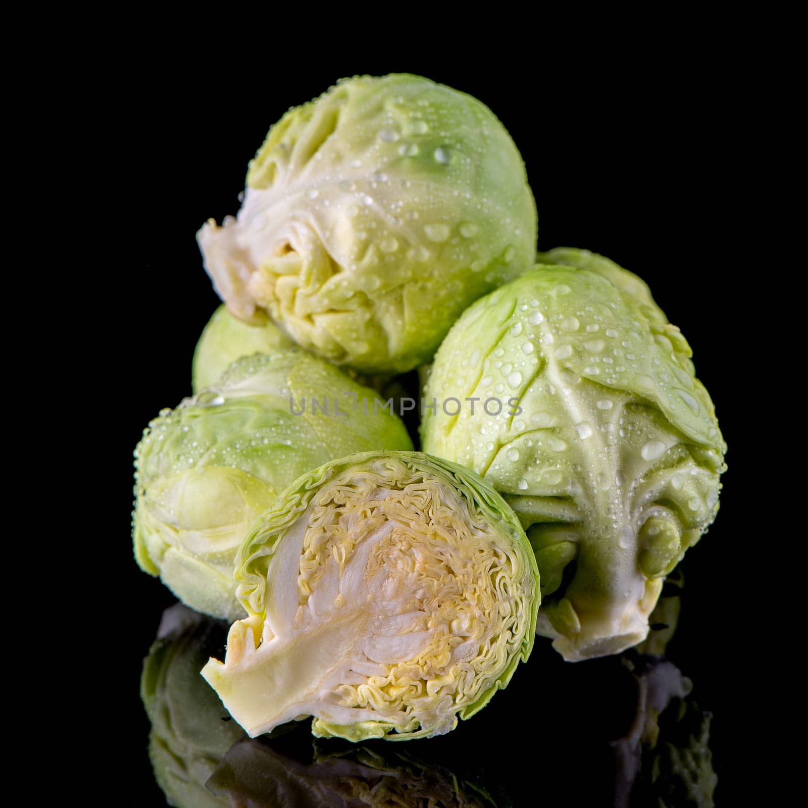 Fresh brussels sprouts isolated on black background.