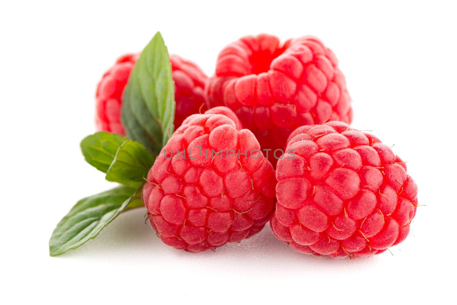 Raspberries with leaves isolated on white background