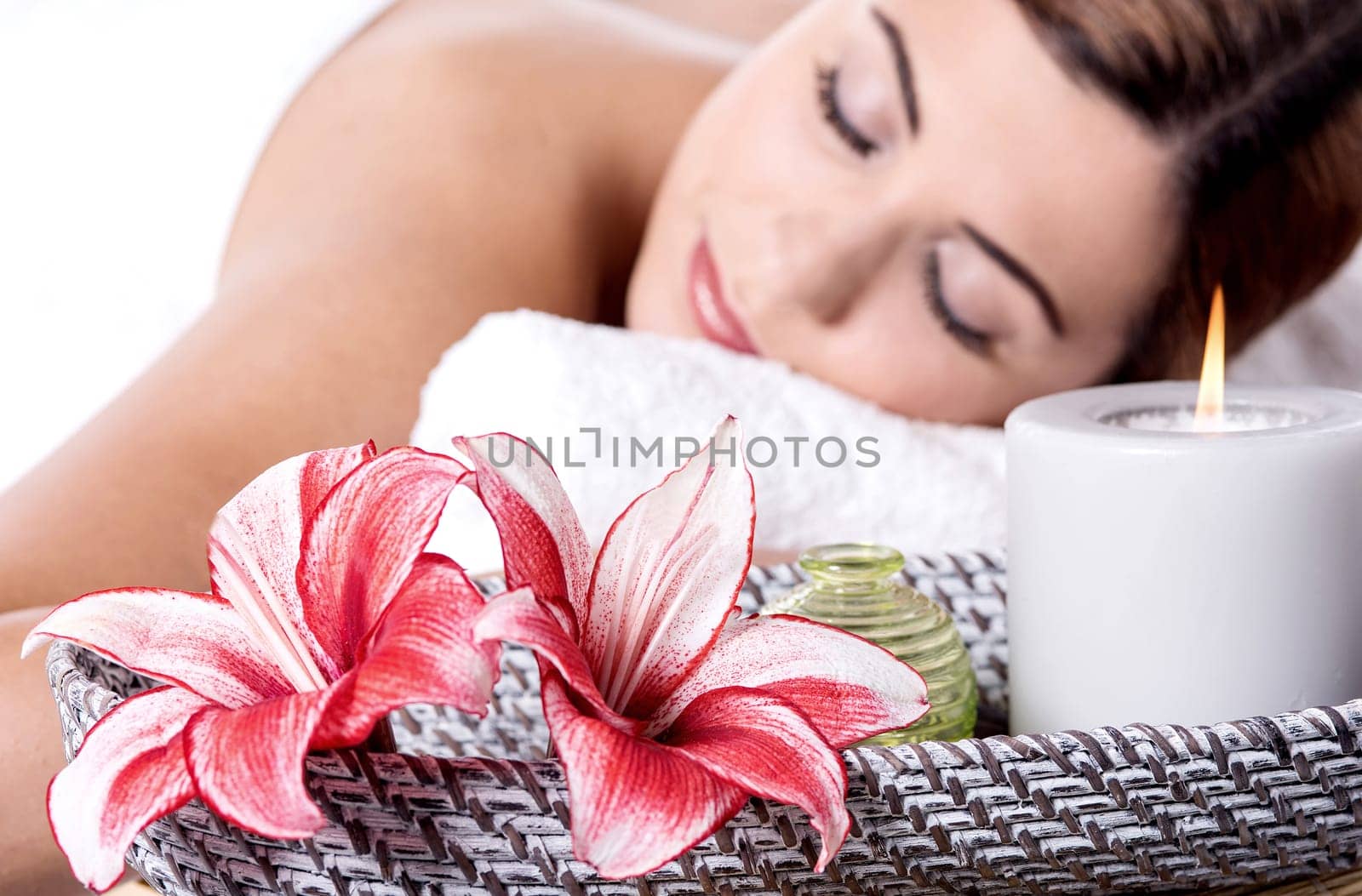 Beautiful woman relaxing in spa with closed eyes