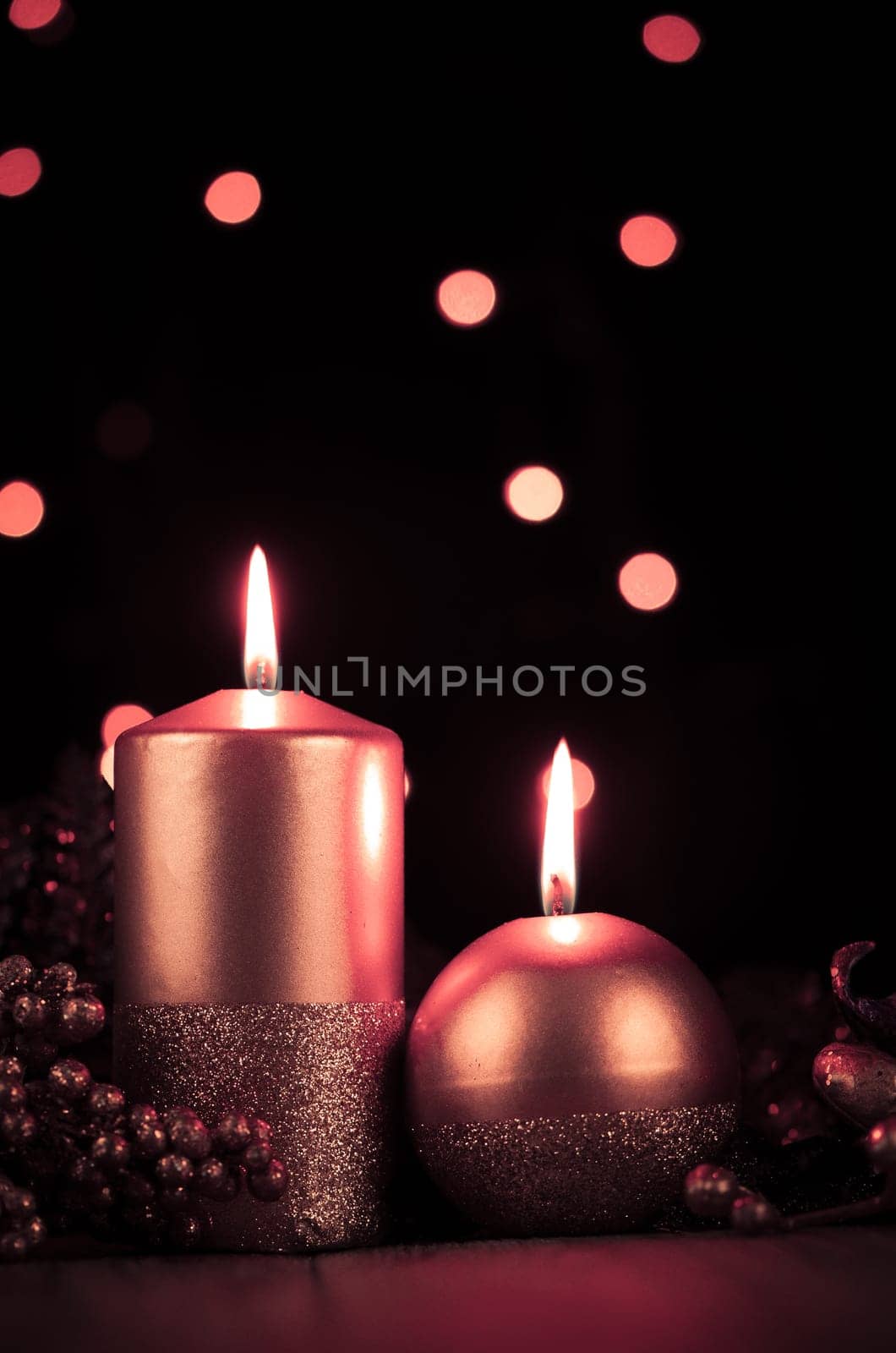 Christmas candles set against black background.