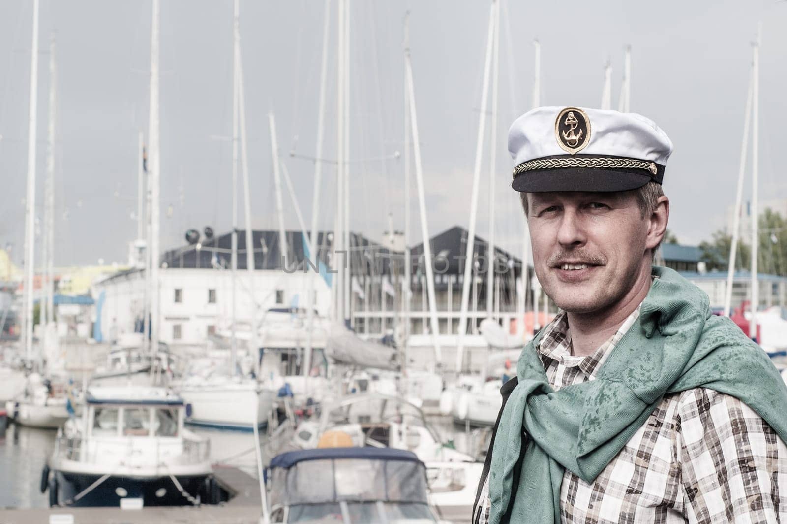 Portrait of a man in a sailor's Cap on the deck of a sailboat