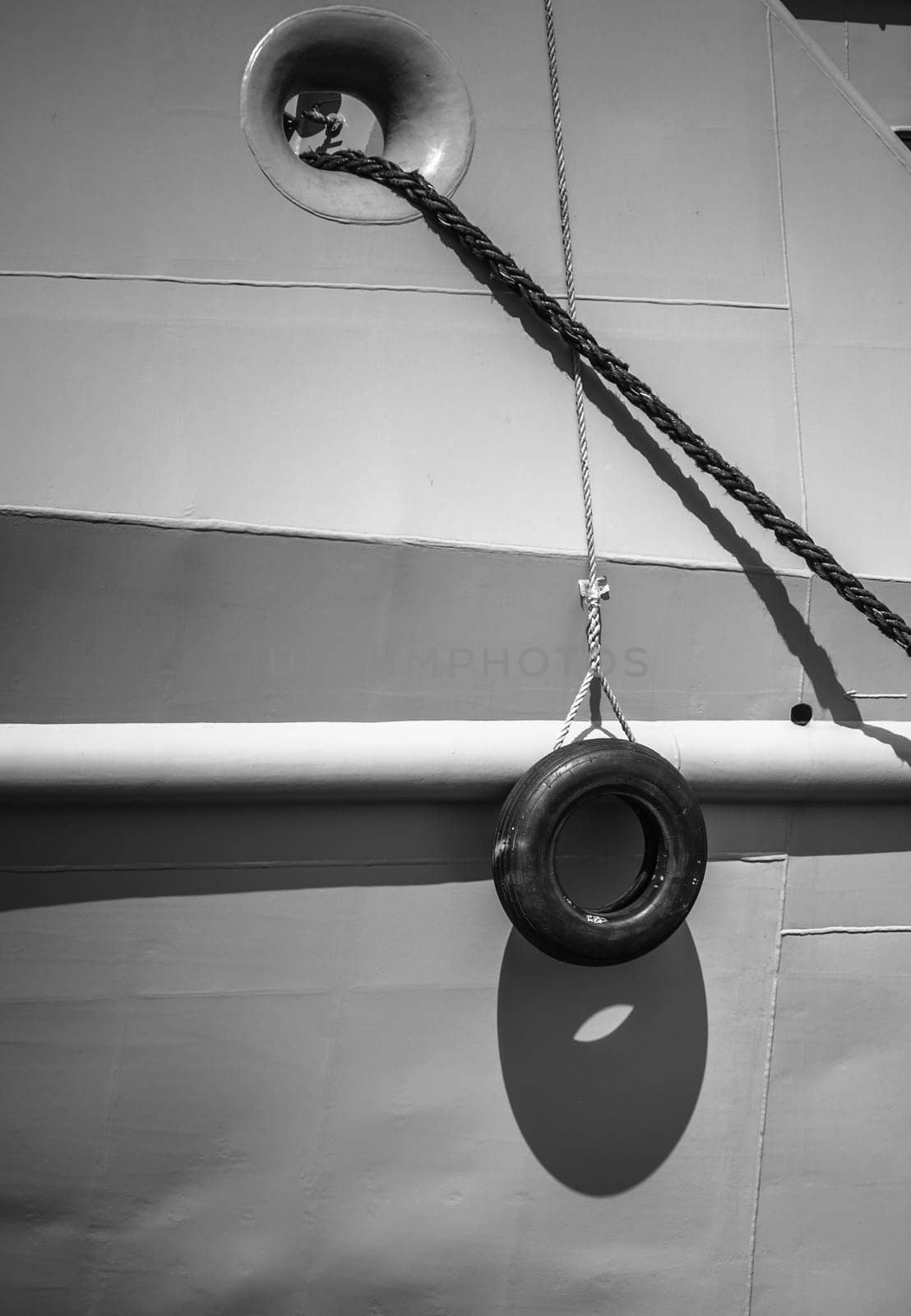 Car tire hanging off the side of the ship