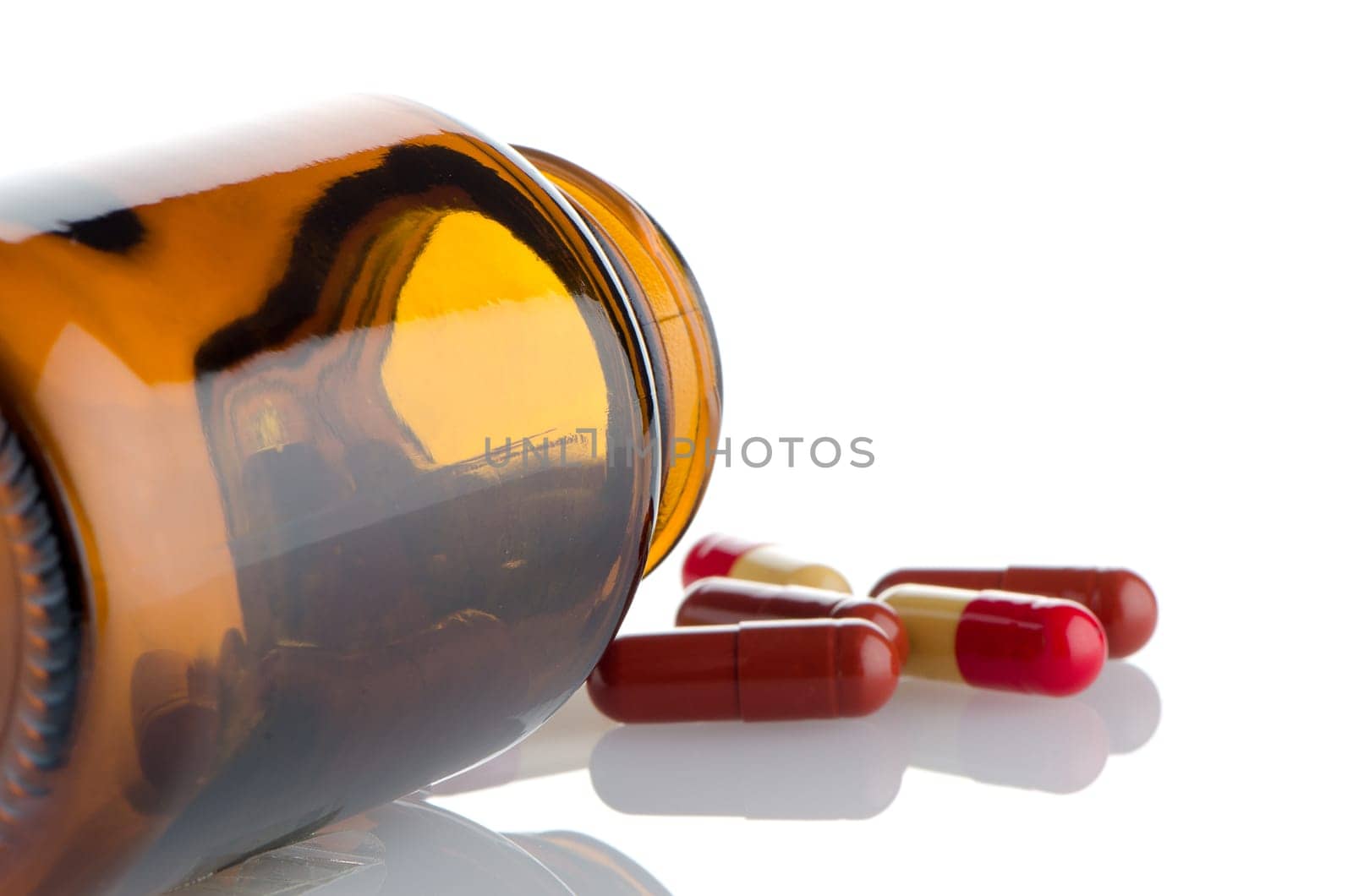 Pills from bottle on the white background.
