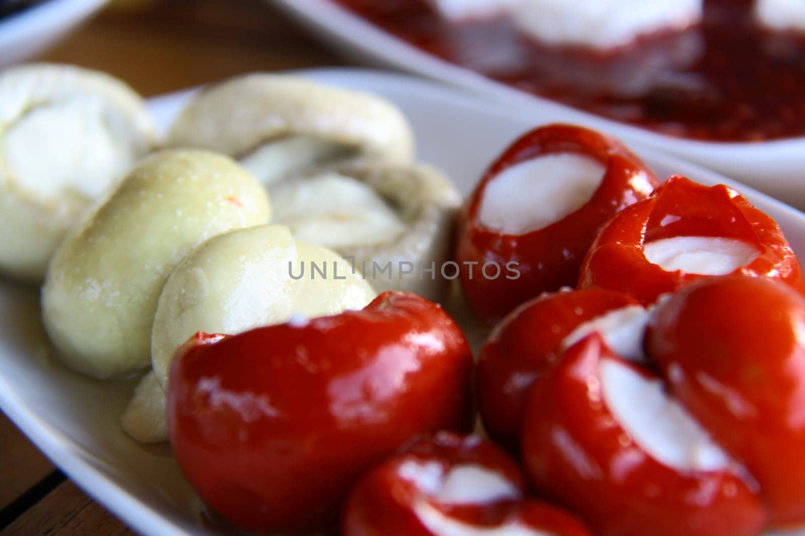 cheese in red pepper at Turkish breakfast on white table close up