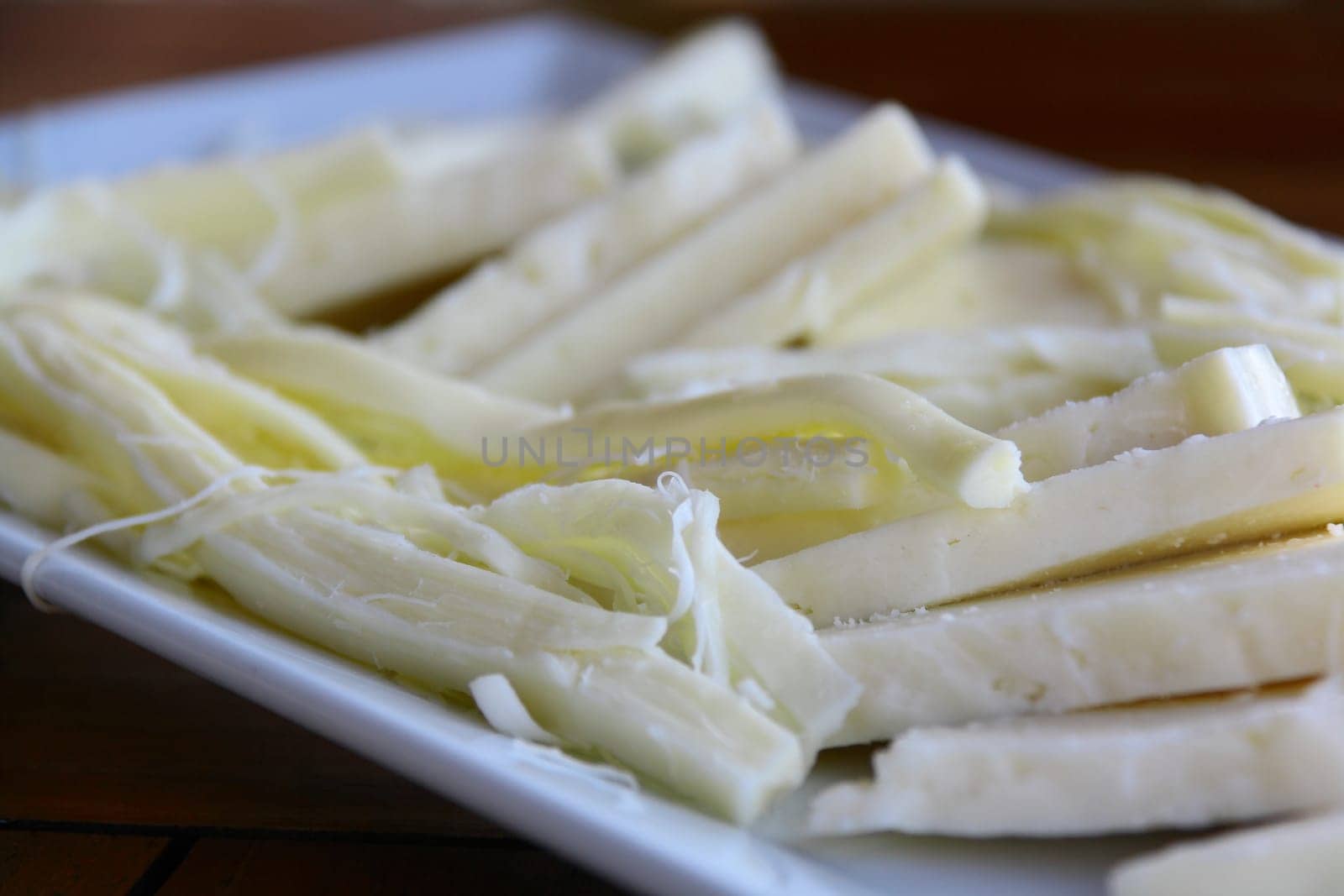 cheese in Turkish breakfast on white table close up