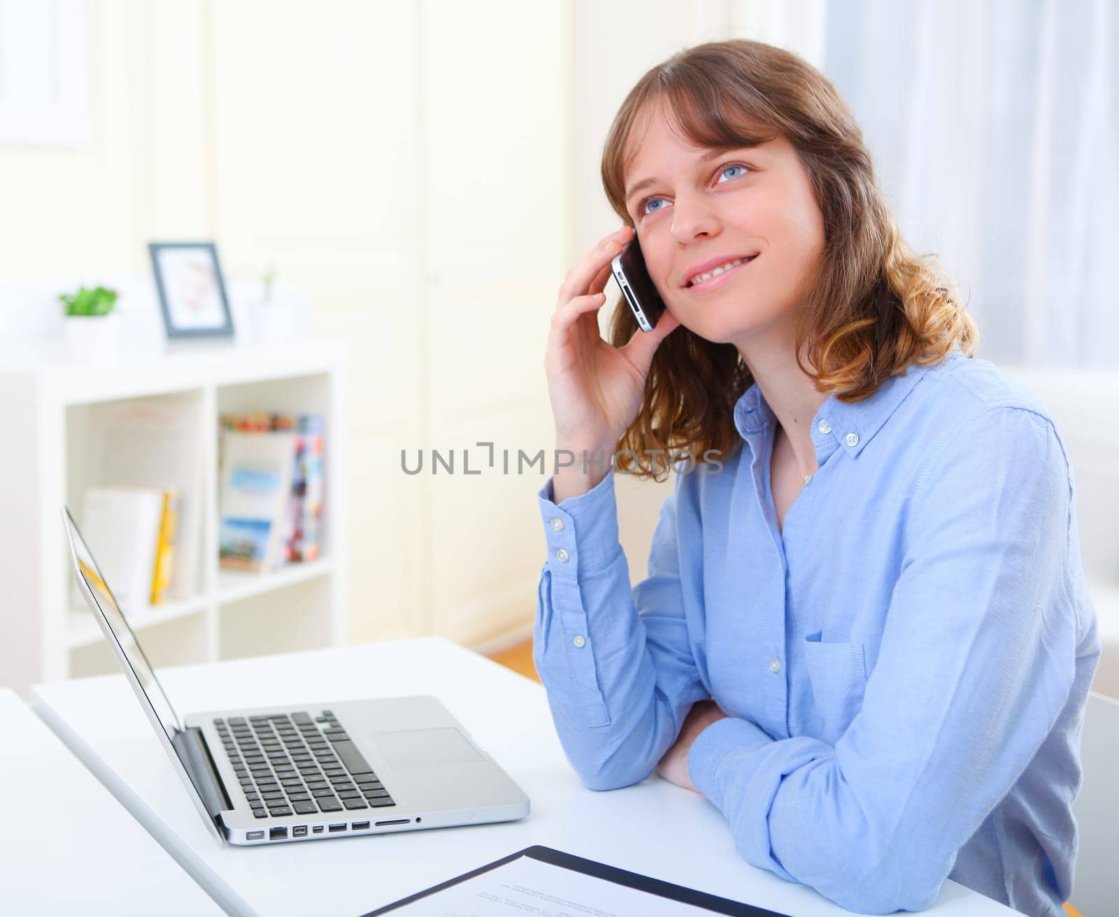 View of a Portrait of young business woman talking on telephone