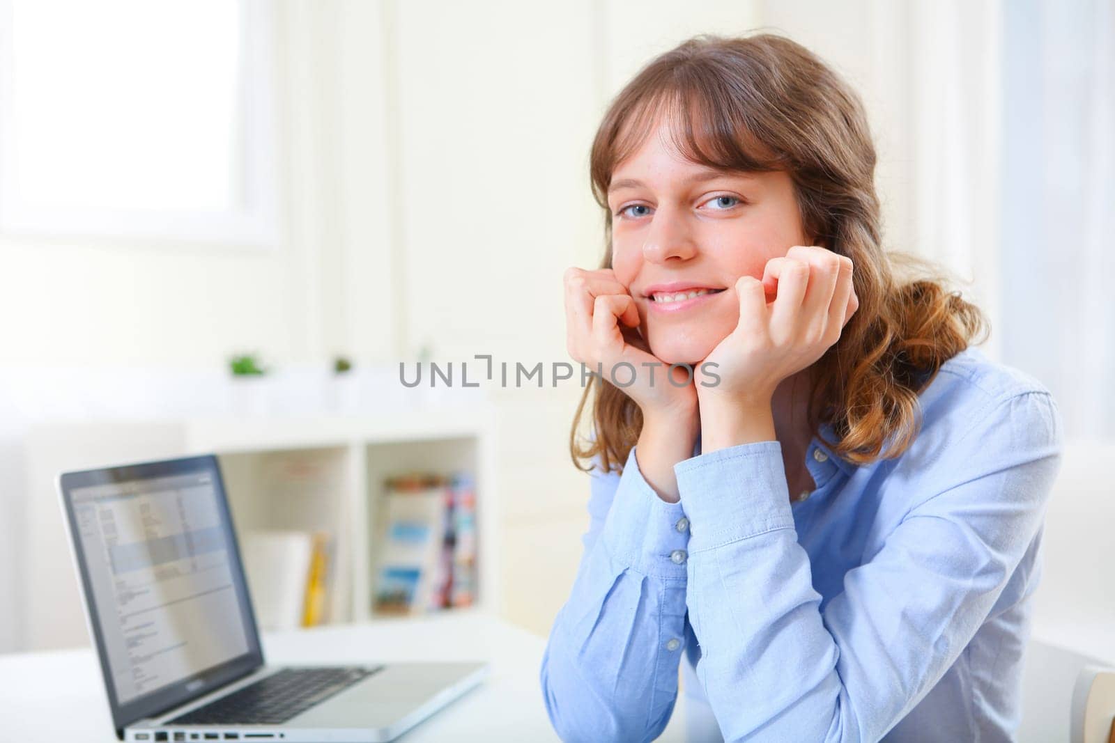 View of a young smiling business woman at work
