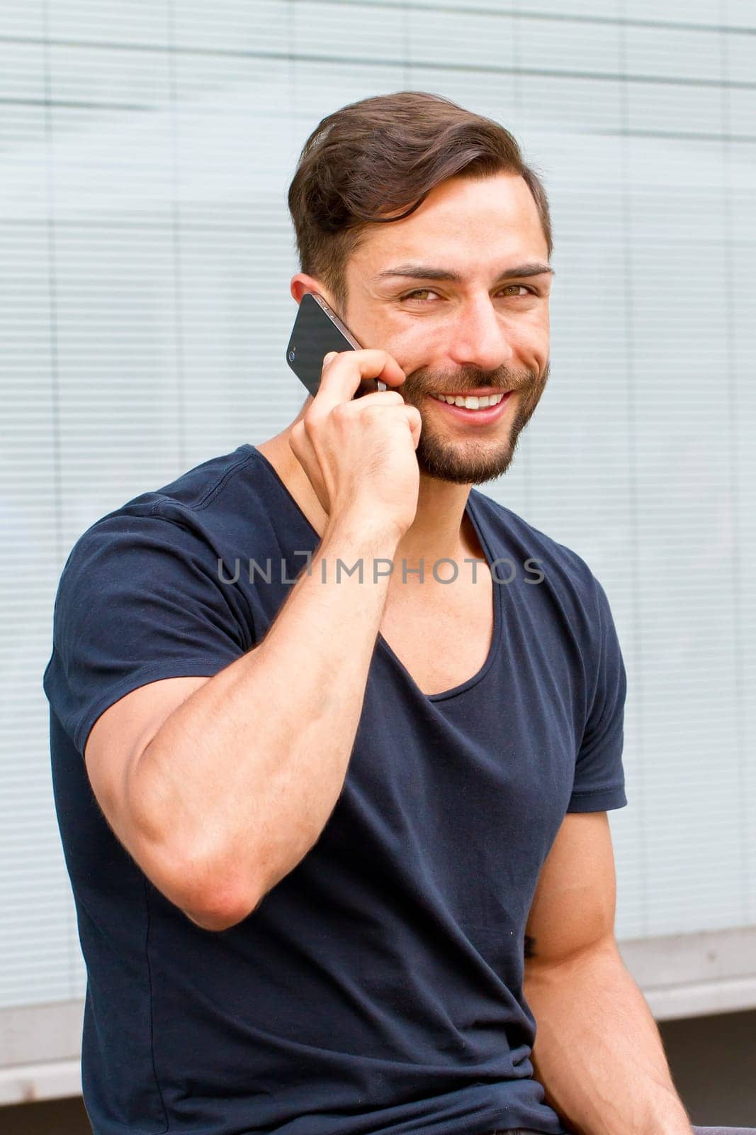 Young man on the phone in the city