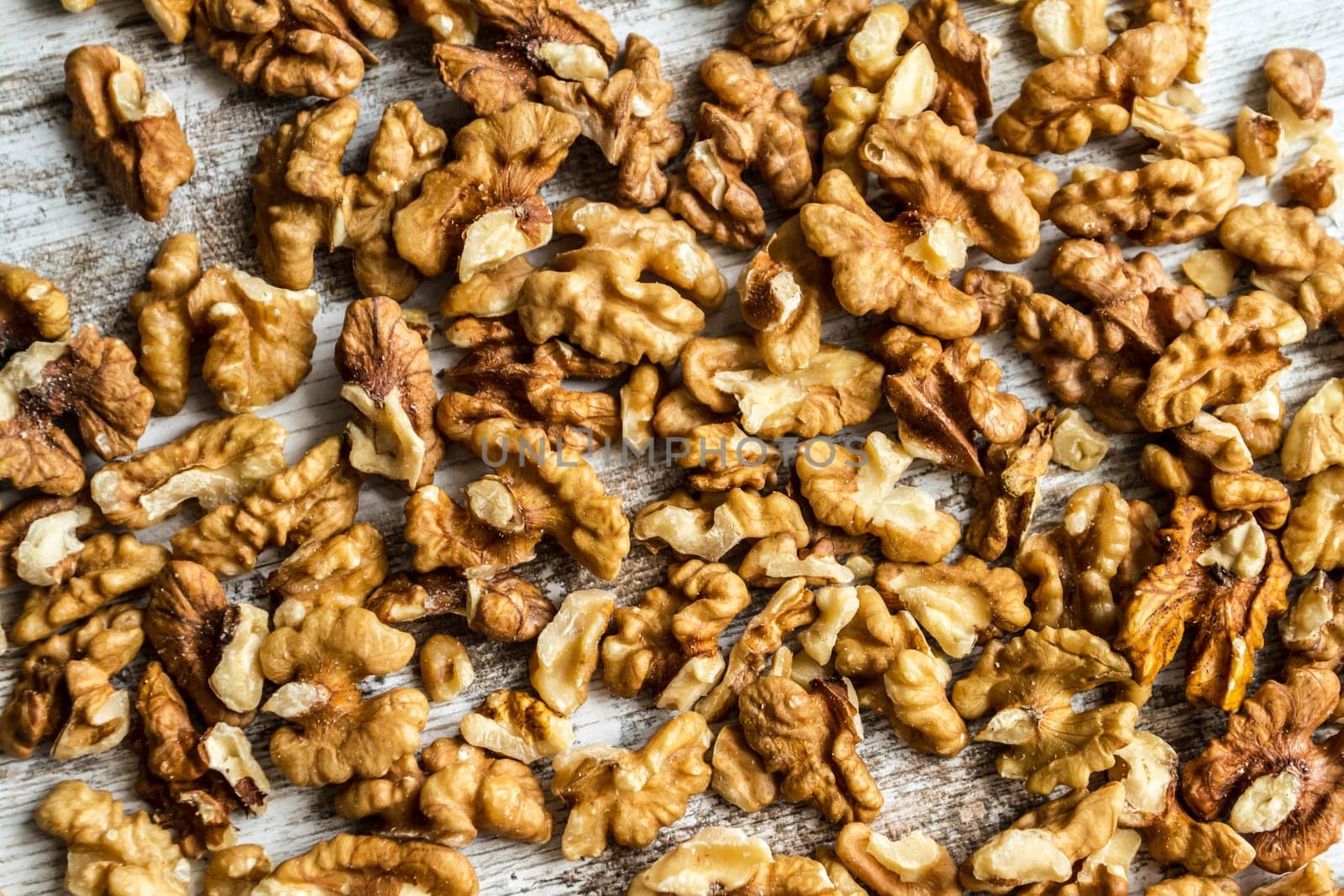 Many Walnuts over a wooden table, background.