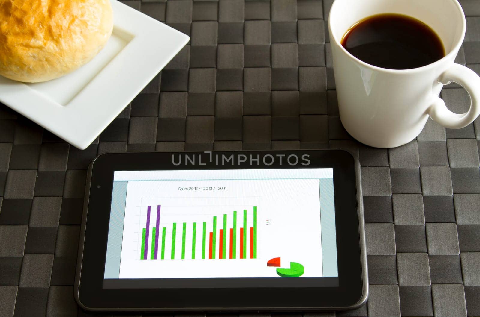 Working, analyzing graphics with the tablet and having breakfast.