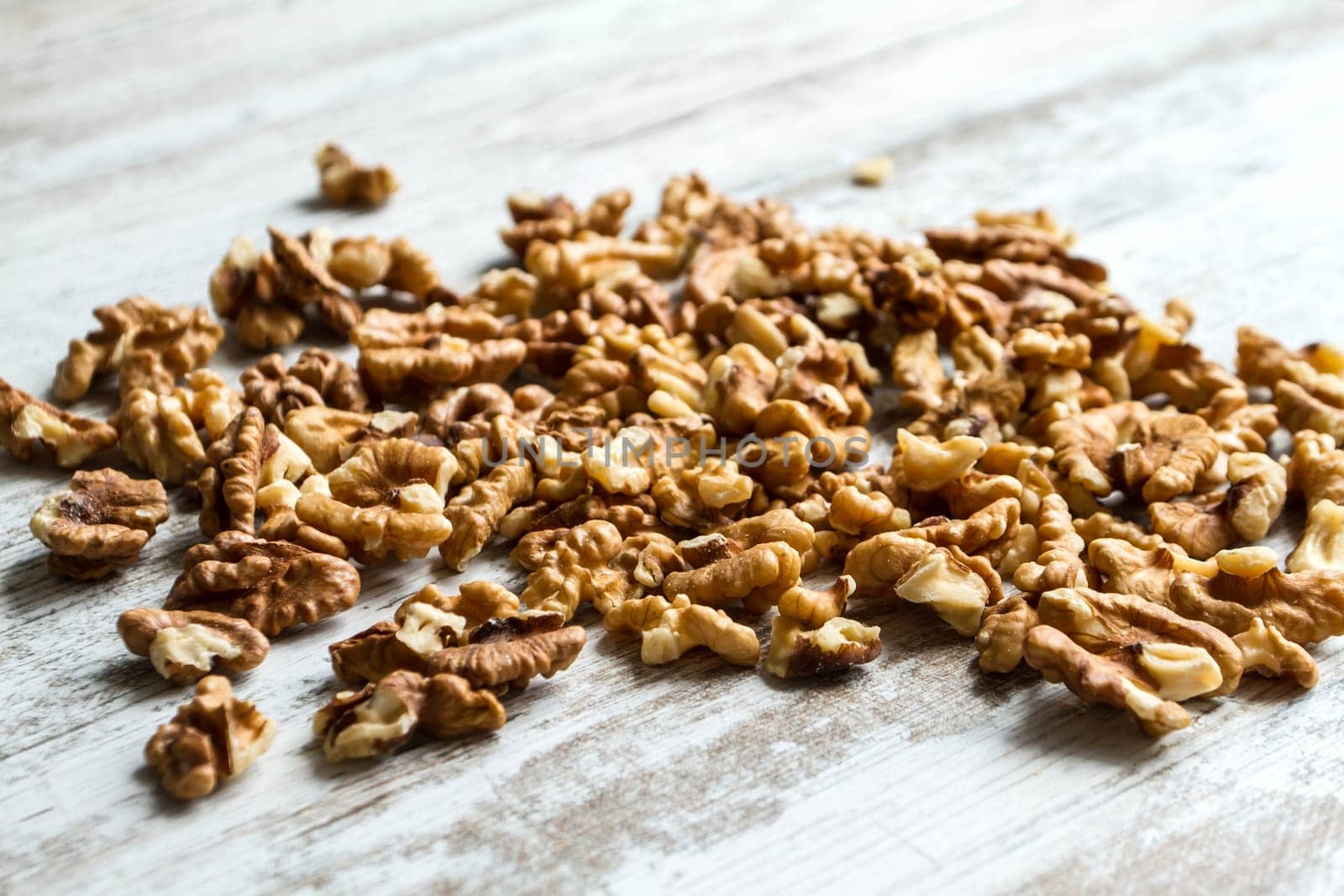 Many Walnuts over a wooden table, background.