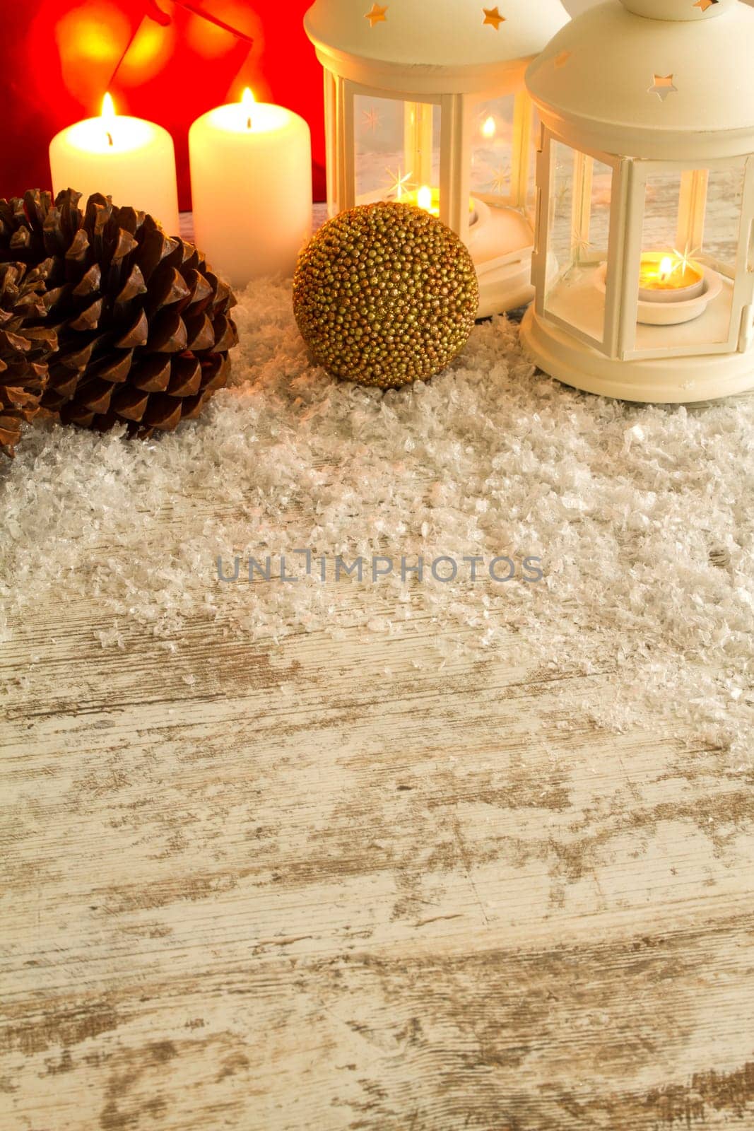 Wooden Christmas background with candles, pine cones, shopping bags and baubles..