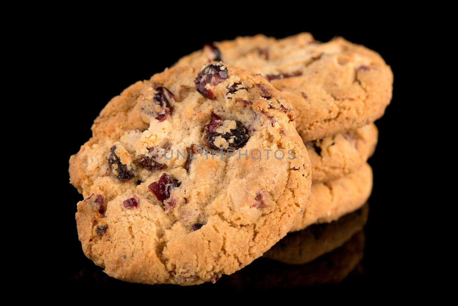Dried fruits chip cookies isolated on black background.
