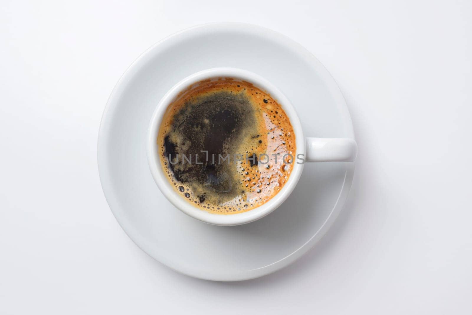 Single cup of coffee top view with plate, empty white background. Clipping path included, so you can easily copy and paste it on your own design.