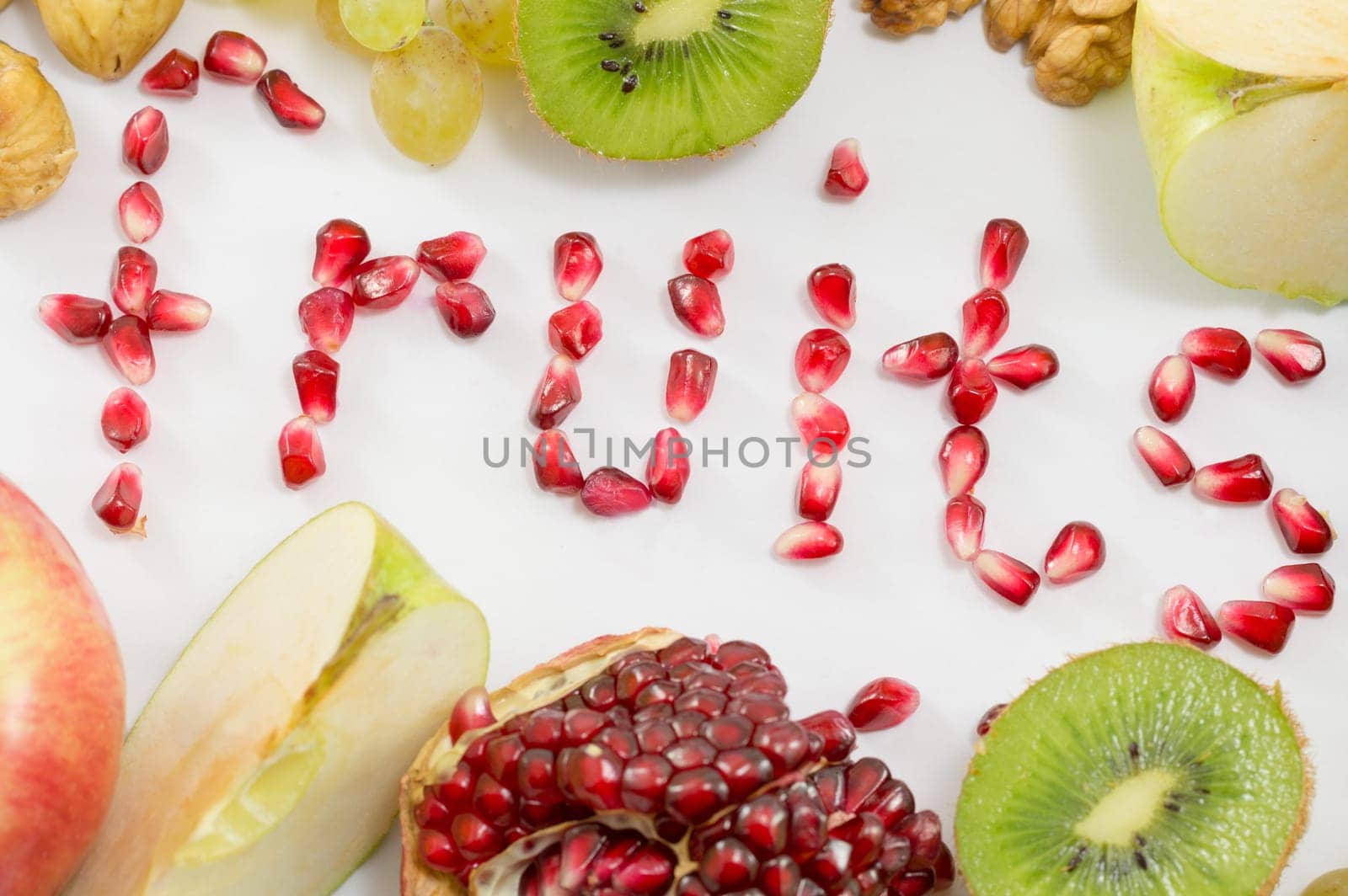 Word fruits written with pomegranate seeds