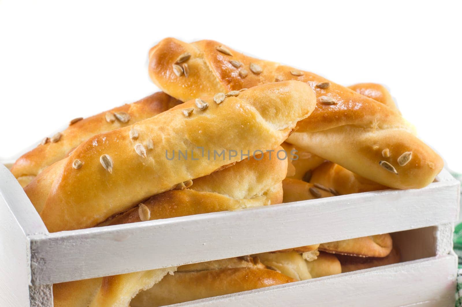 sesame pastry in a white crate isolated