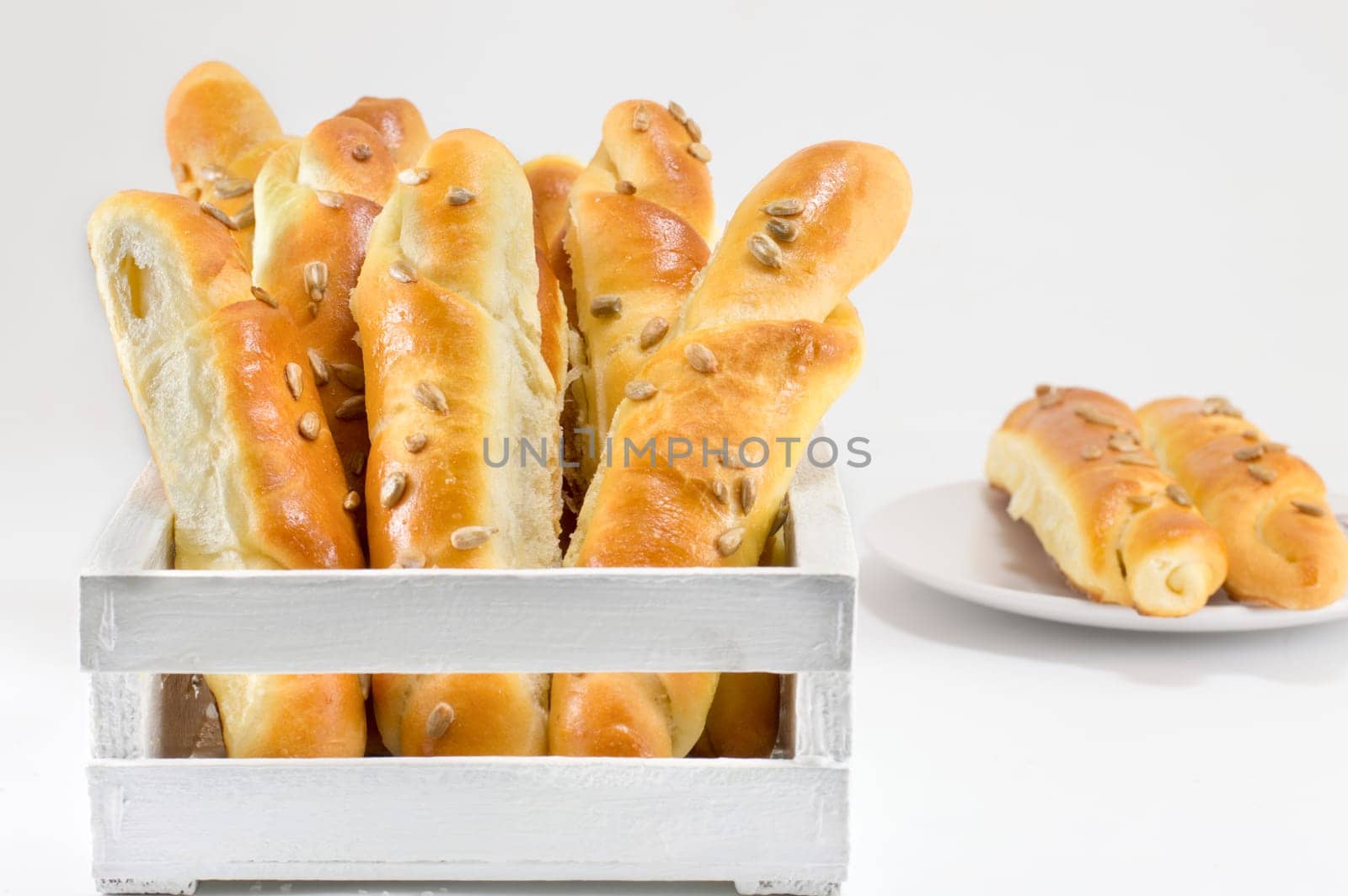 sesame pastry in a white crate isolated