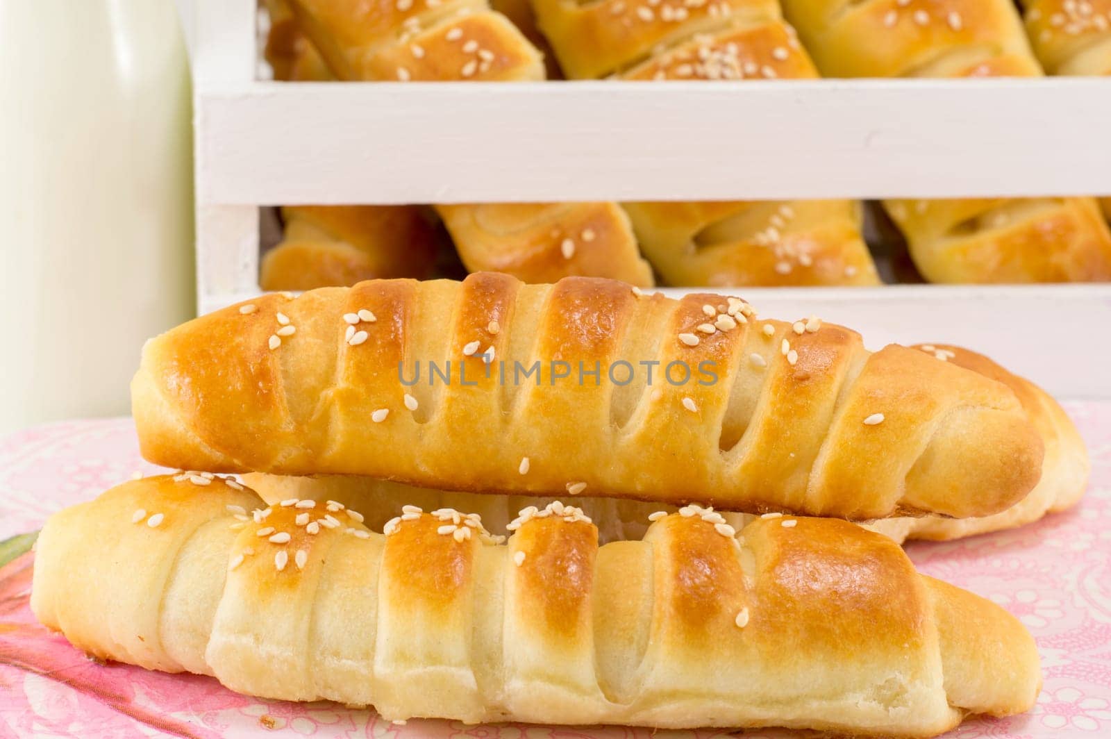 bunch of sesame pastry in a white crate