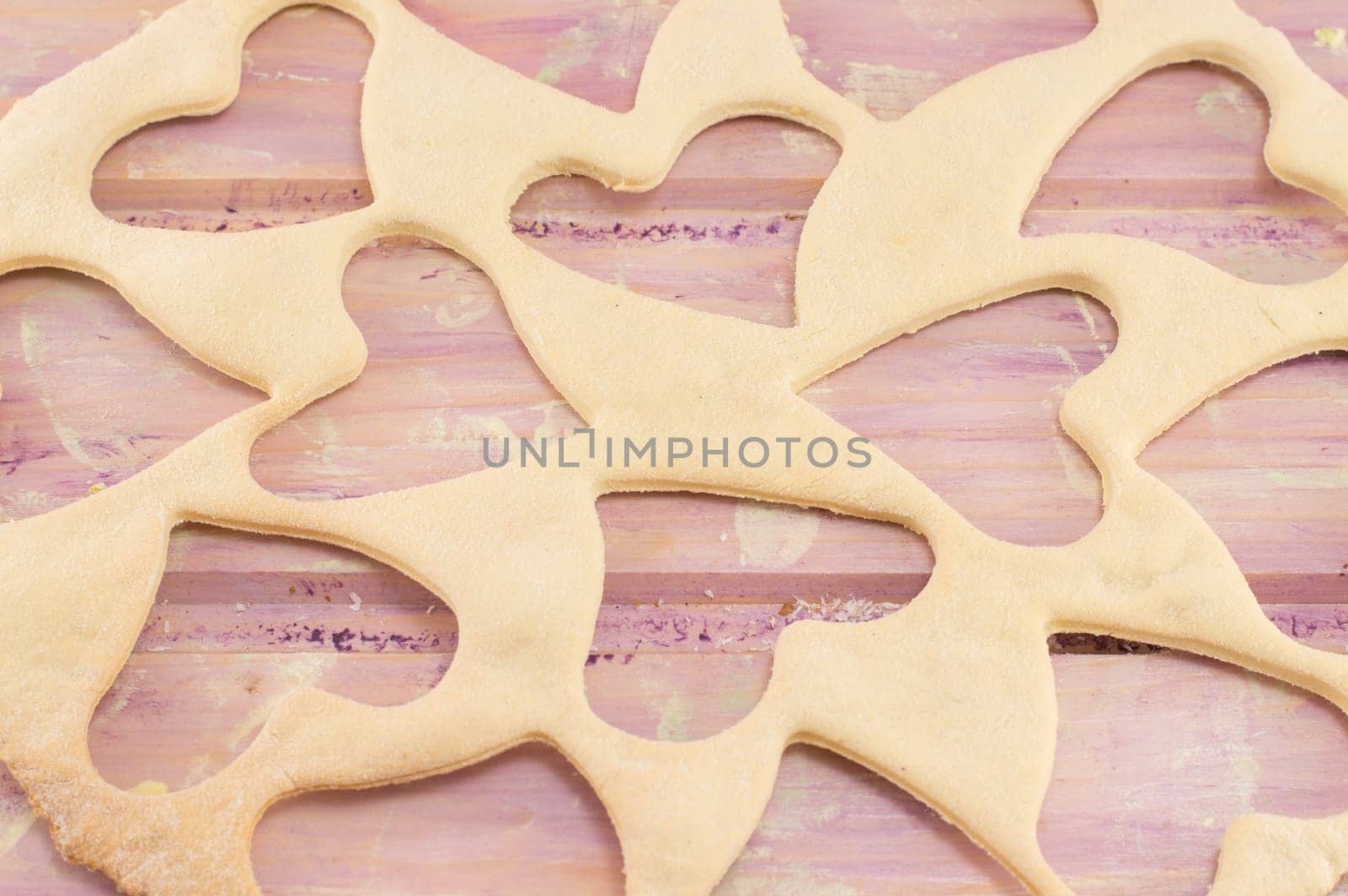 dough with hearts cut out on a wooden table