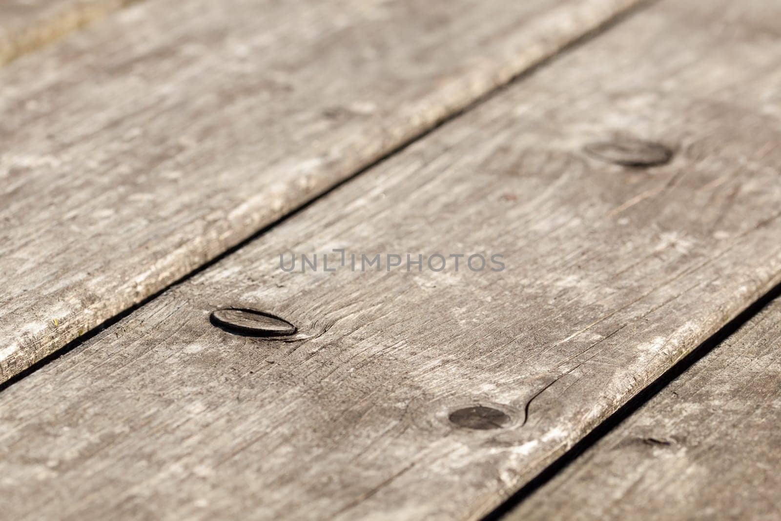 Wood grain with branches - weather-resistant wood surface of a garden table