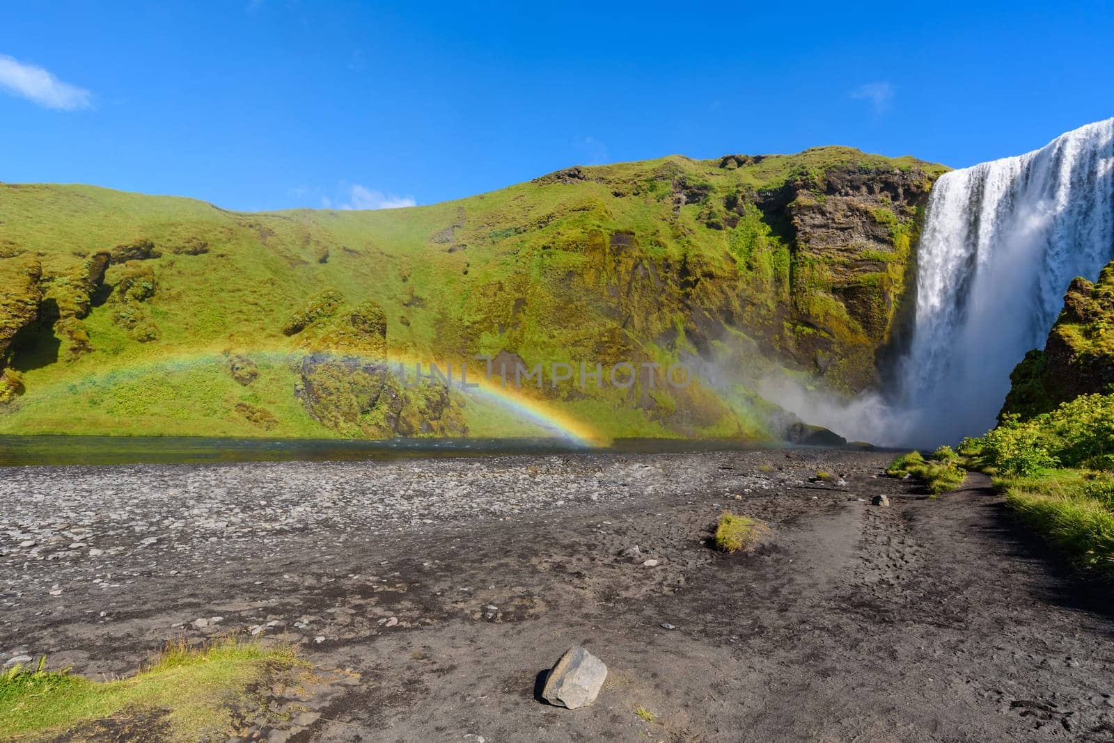 beautiful waterfall Skogafoss with rainbow, famous natural landmark in Iceland