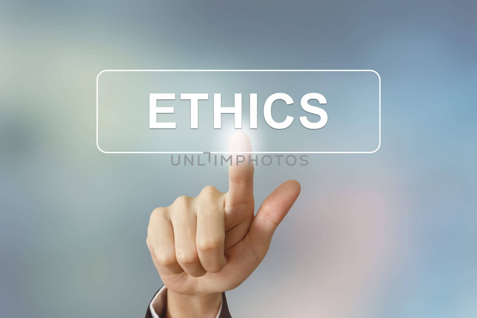 business hand pushing ethics button on blurred background