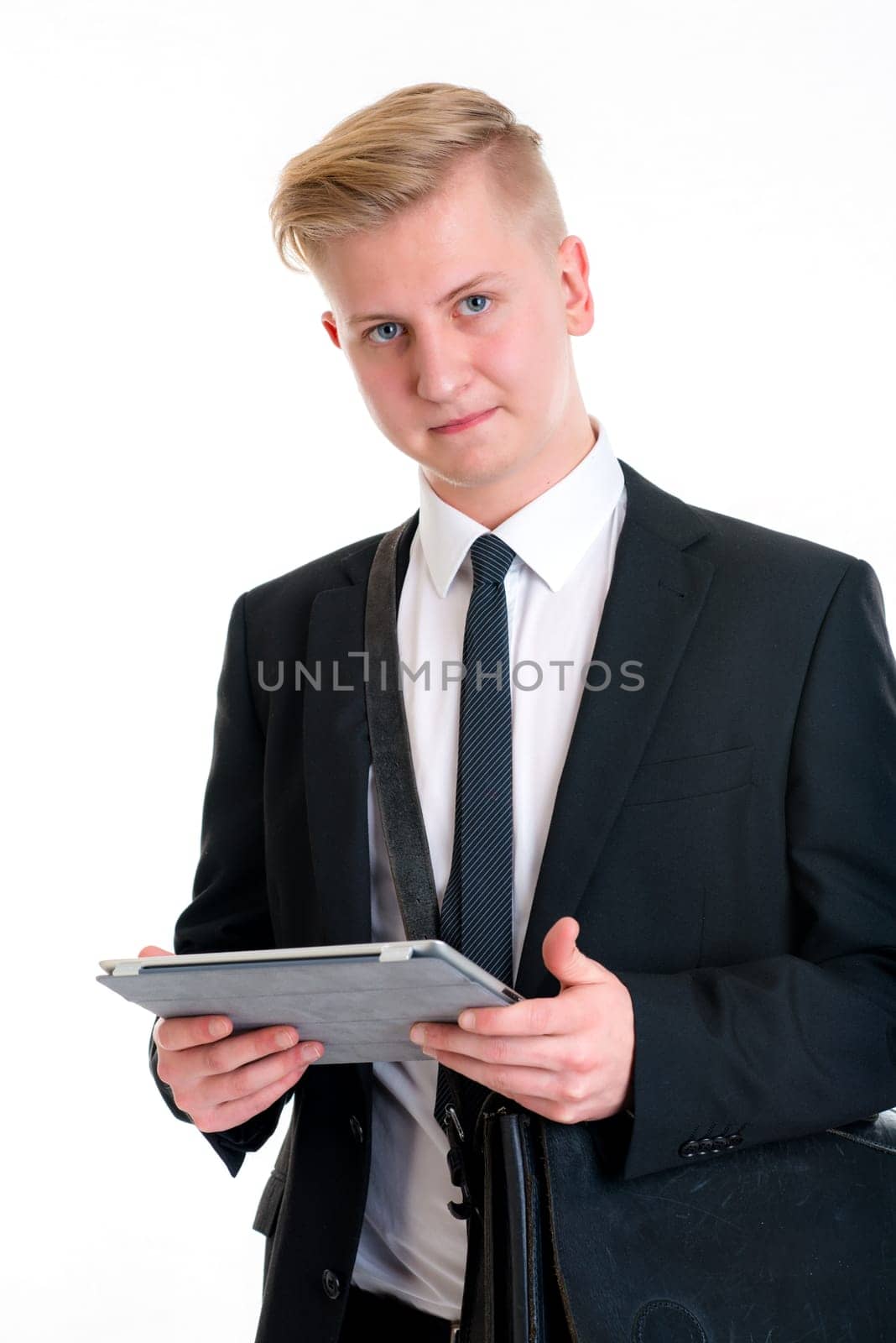 portrait of a young business man in black suit with tablet PC