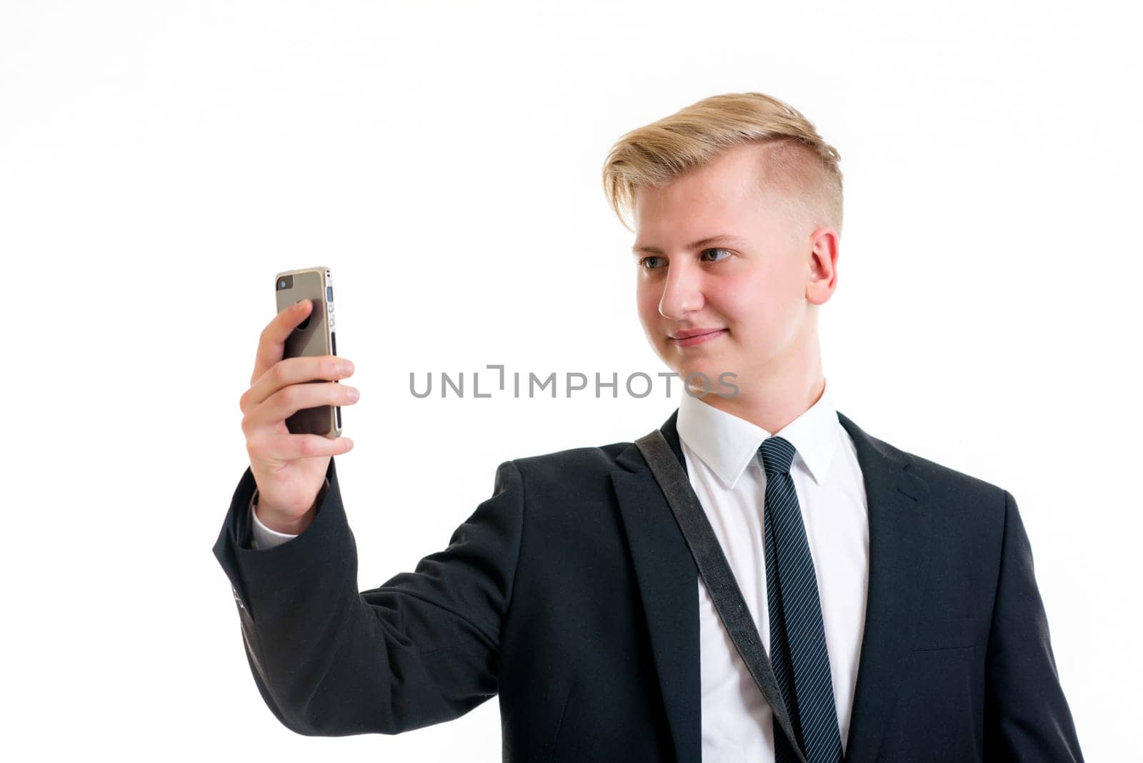 young business man in black suit taking a self-portrait with his phone