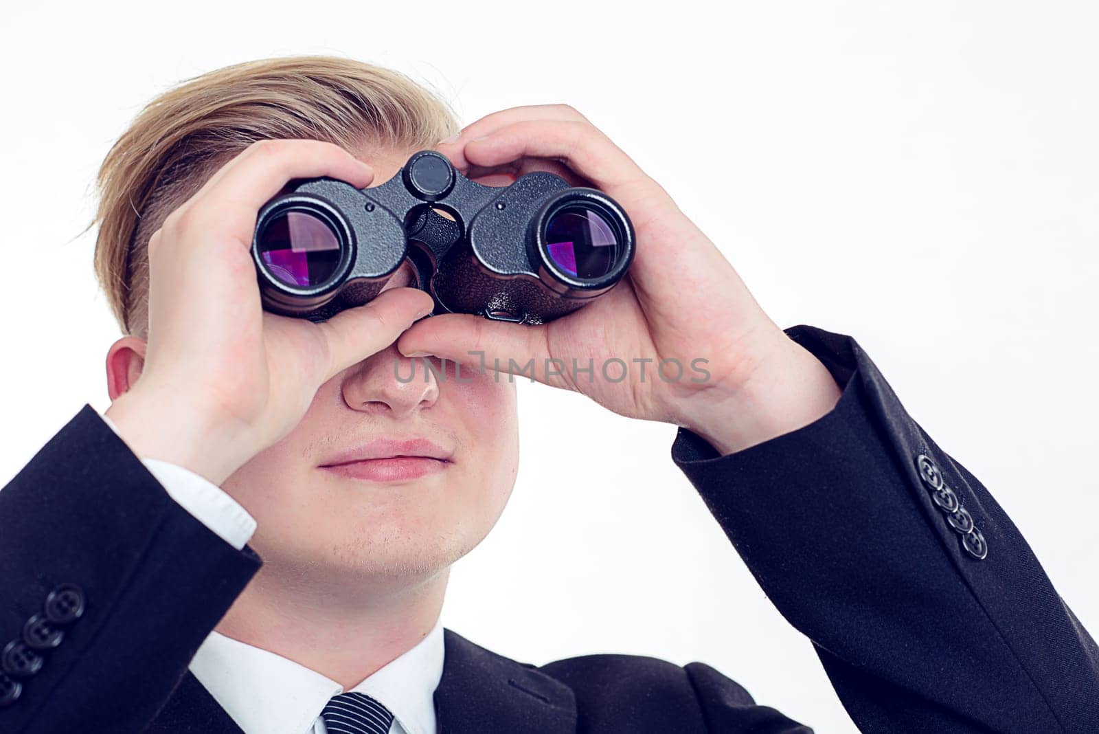 young business man is looking through binoculars