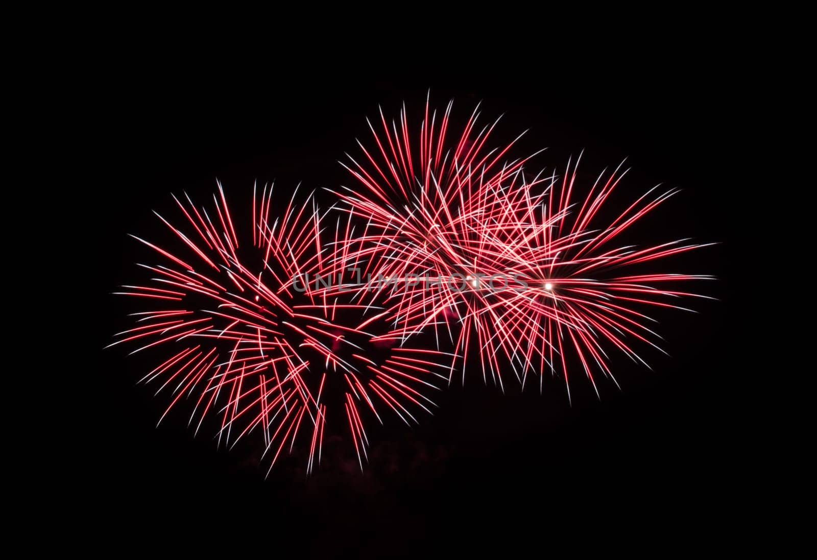 Red fireworks exploding in the night sky