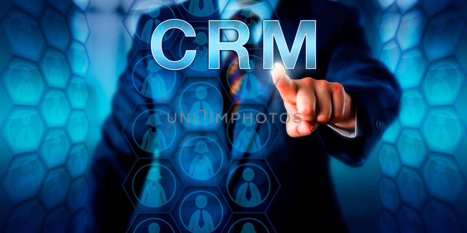 Manager is pushing CRM on a touch screen interface. Female and male business people icons embedded in hexagonal matrix structures do represent customer data compiled in an information system..