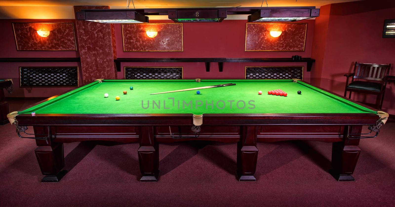 A Pool Table, set up for a game,  front view